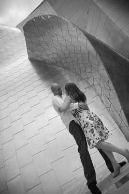 Dancing engagement shot of a couple who got engaged at Walt Disney concert hall in downtown Los Angeles. Black and white photo showing lots of reflections.