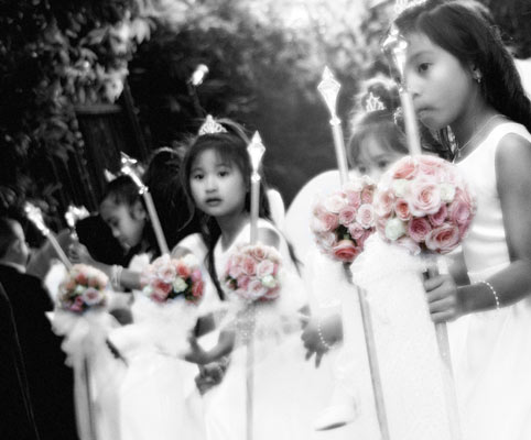 Classic photojournalistic photo of the flowergirls holding their bouquets at the ceremony.