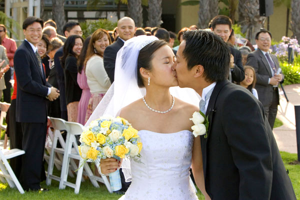 Hollywood wedding couple kiss at the end of their ceremony in this shot.