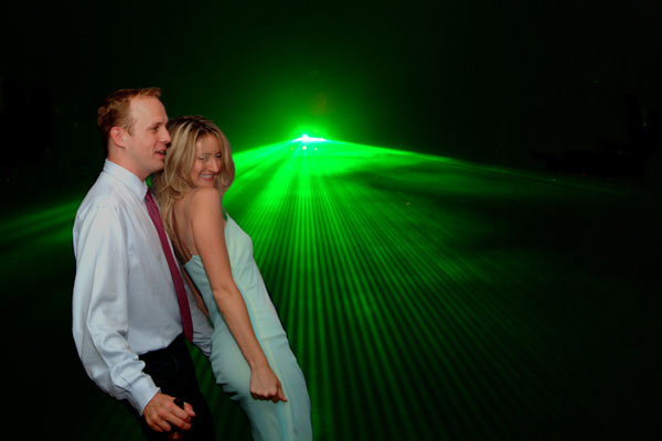 Here we have a photo from a wedding in Santa Barbara, with a couple dancing at the reception in front of lasers.